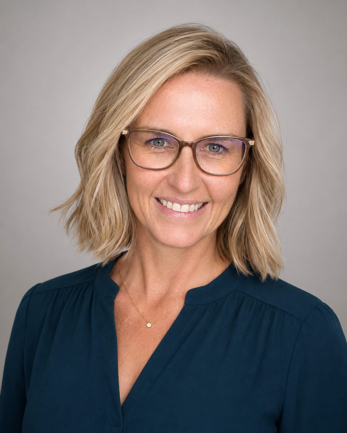Melissa Waller, in a gray-toned professional headshot.